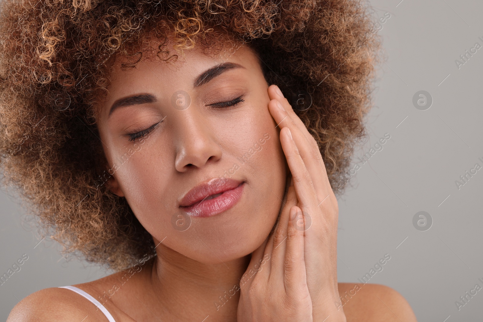 Photo of Beautiful woman with healthy skin on gray background