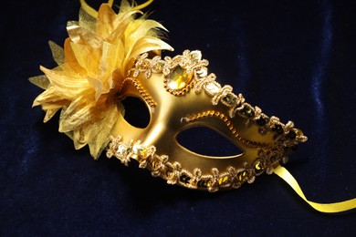 Theater arts. Golden venetian carnival mask on blue fabric