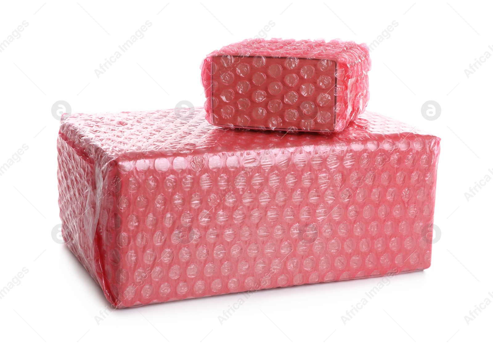 Photo of Cardboard boxes packed in red bubble wrap on white background