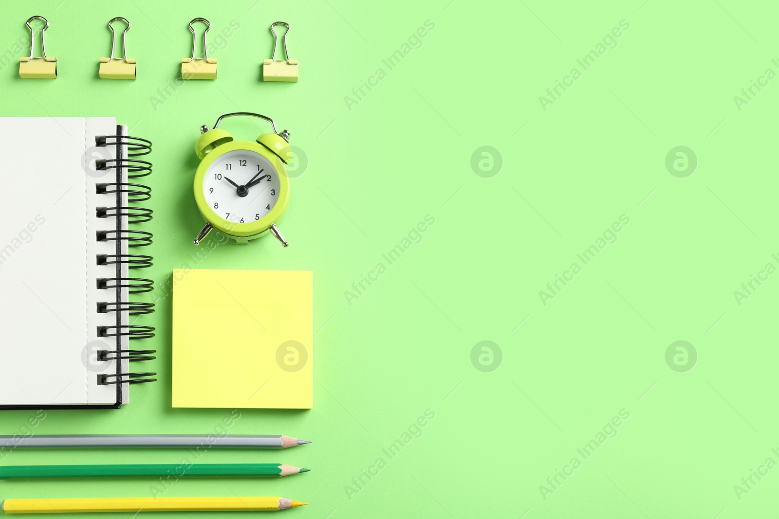 Photo of Modern office accessorises on green background, flat lay. Space for text