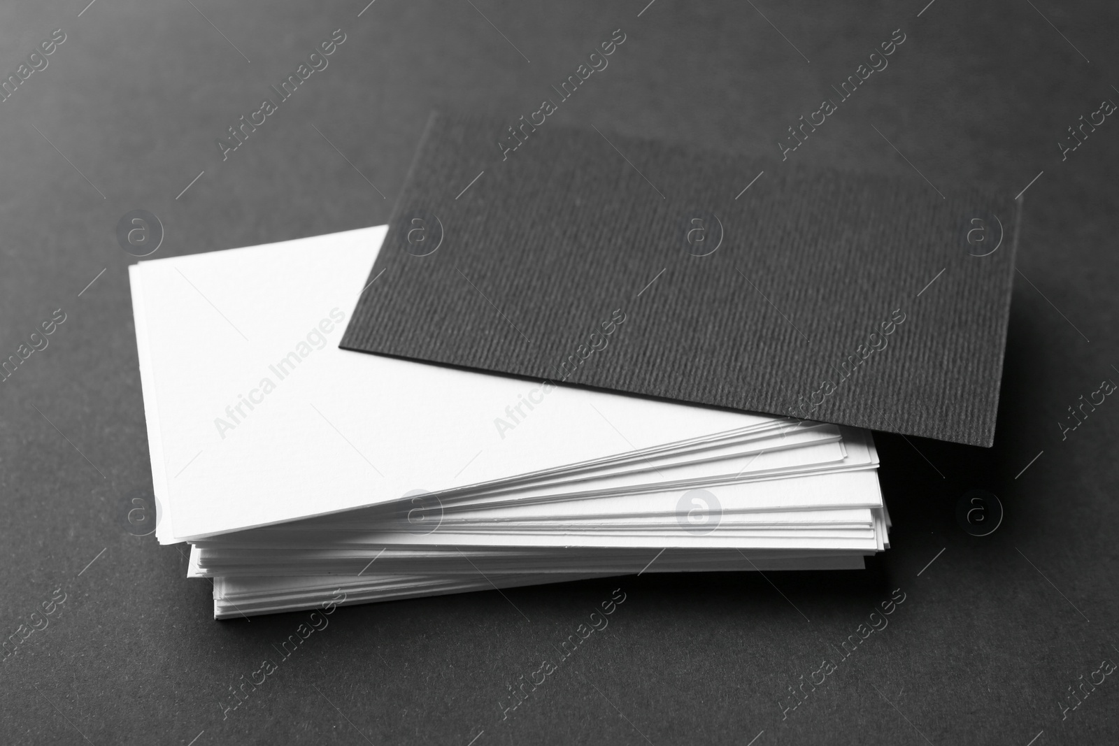 Photo of Many business cards on black background, closeup. Mockup for design