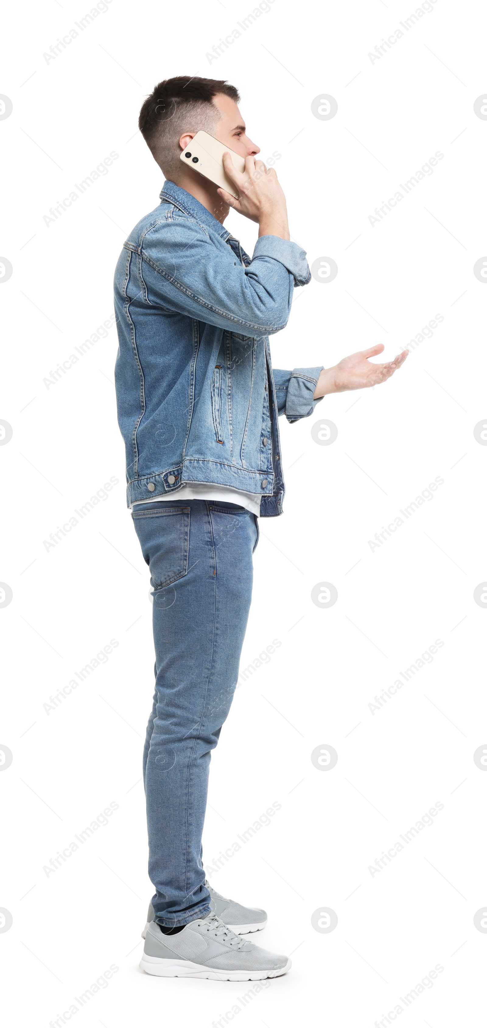 Photo of Man in denim clothes talking on phone isolated on white