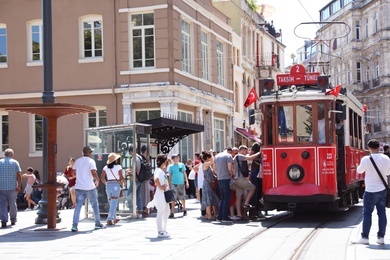 Photo of ISTANBUL, TURKEY - AUGUST 10, 2019: Old tram and people on city street