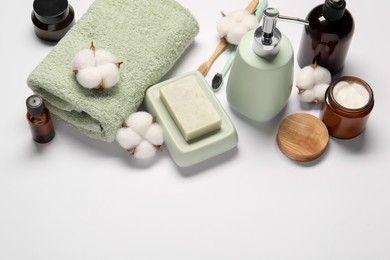 Photo of Bath accessories. Different personal care products and cotton flowers on white background