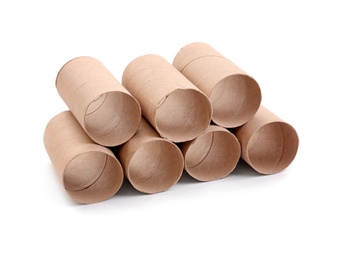 Stacked empty paper toilet rolls on white background