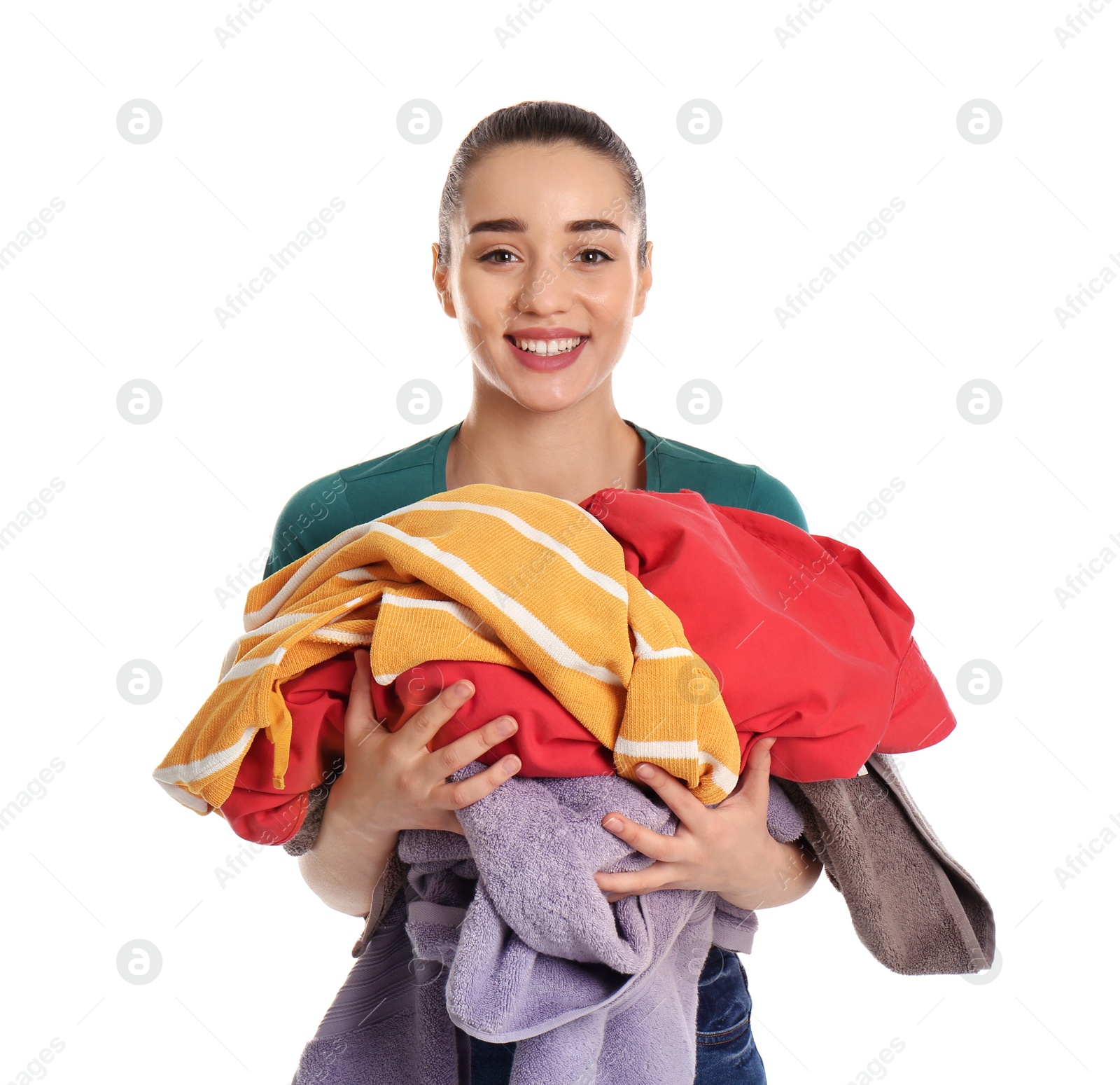 Photo of Happy young woman holding pile of dirty laundry on white background