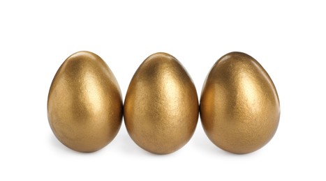 Many shiny golden eggs on white background