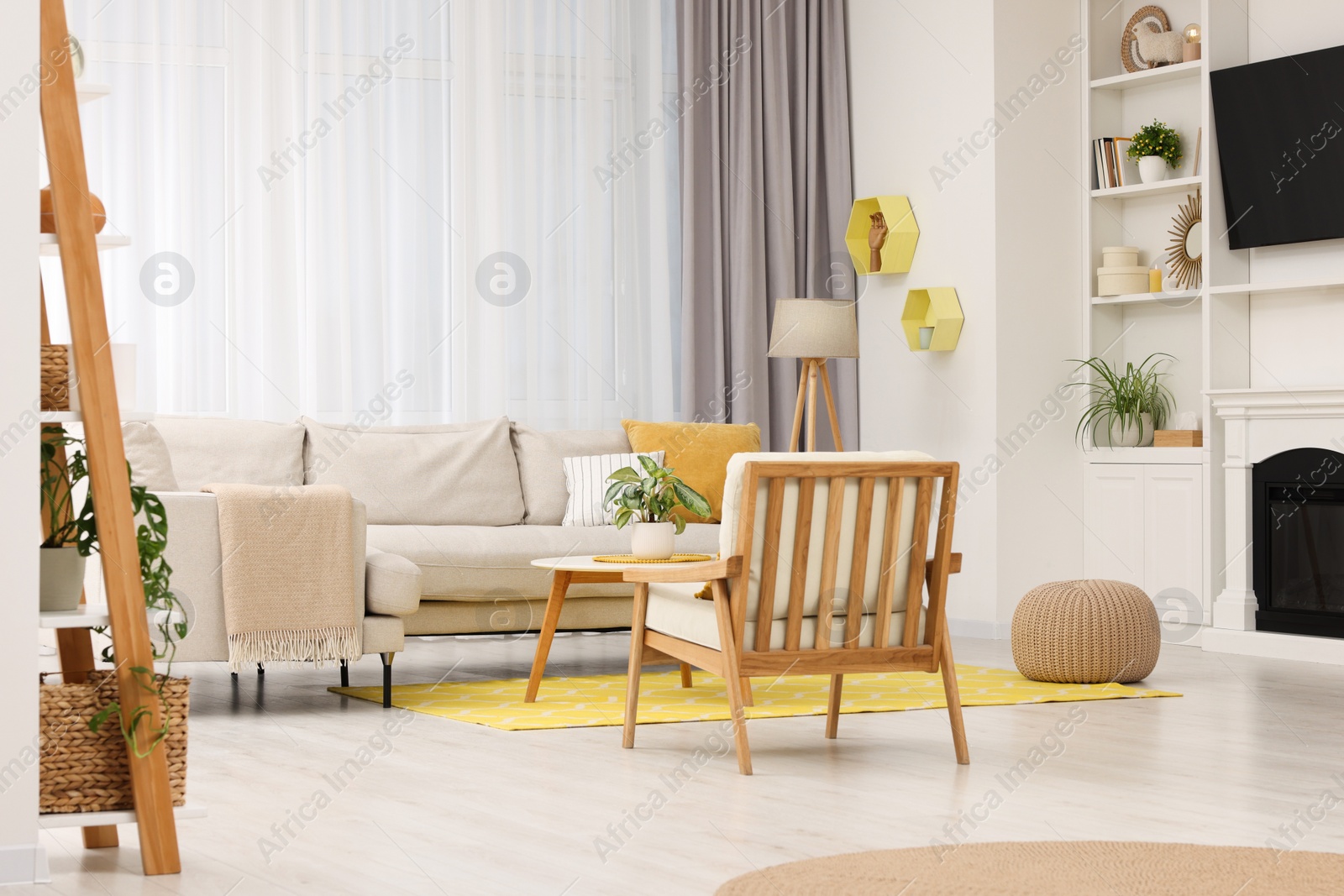 Photo of Spring atmosphere. Stylish room interior with cozy furniture in yellow and white colors