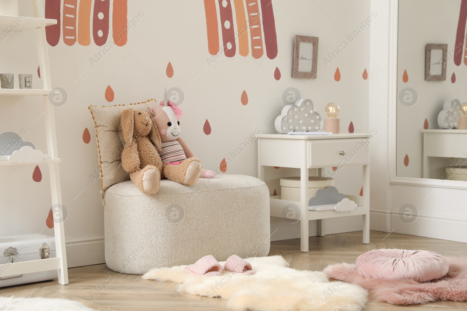 Photo of Child's room interior with rainbow painting on wall