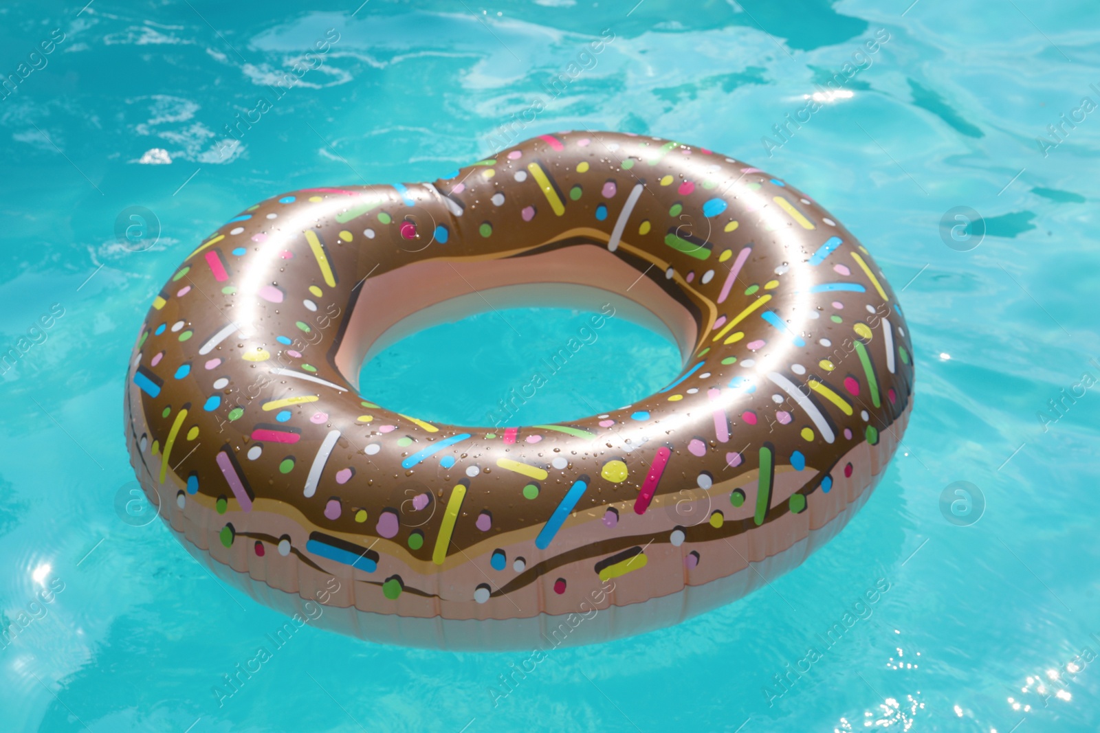 Photo of Inflatable ring floating on water in swimming pool