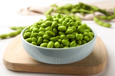 Photo of Bowl of delicious edamame beans on table