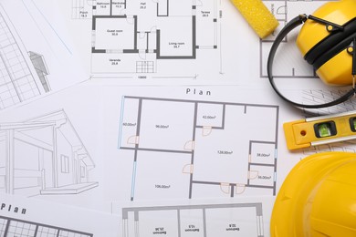 Photo of Flat lay composition with building level and other construction tools on papers