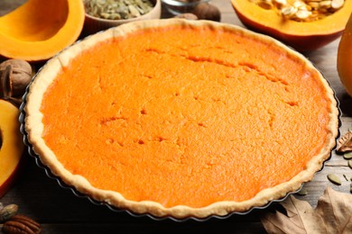 Photo of Delicious homemade pumpkin pie on wooden table, closeup
