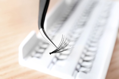 Tweezers with false eyelash, closeup