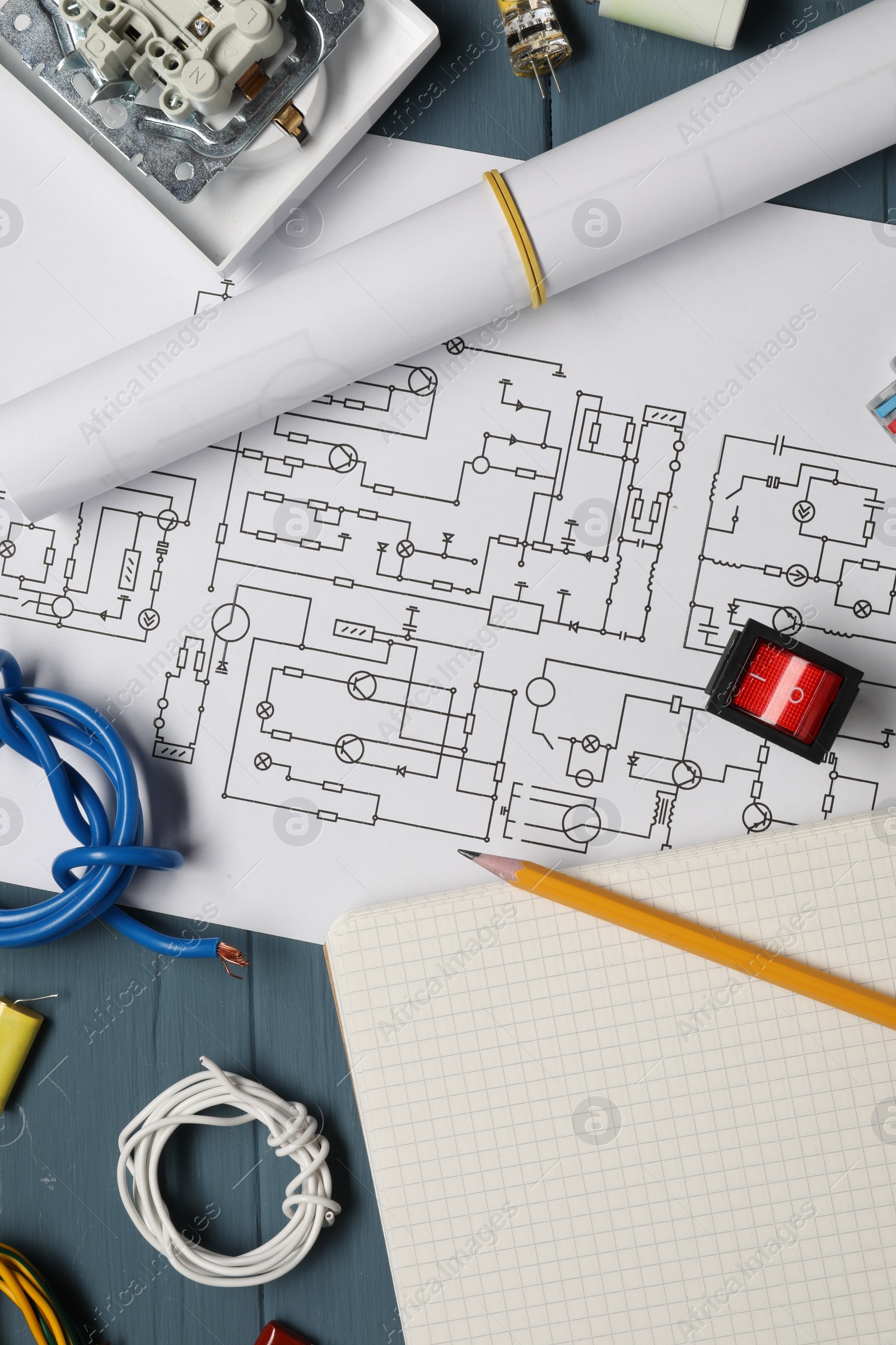 Photo of Flat lay composition with wiring diagram on blue wooden table