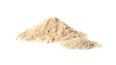 Photo of Piles of flour and sesame seeds isolated on white