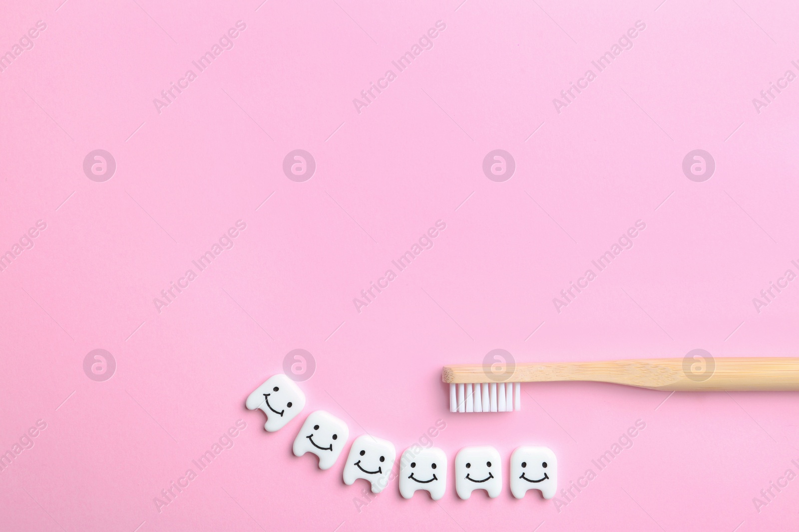 Photo of Flat lay composition with small plastic teeth and space for text on color background