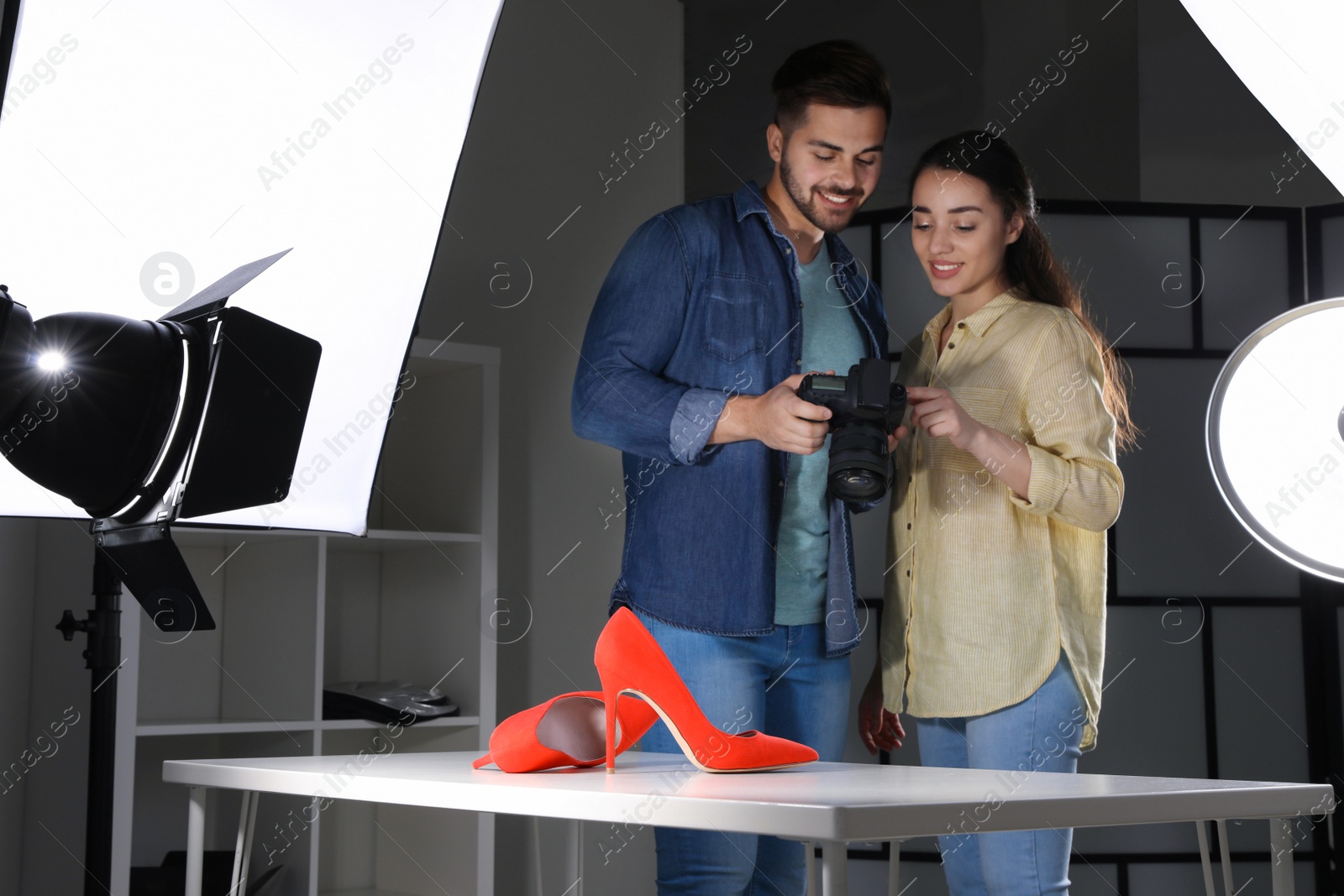 Photo of Professional photographers shooting stylish shoes in studio