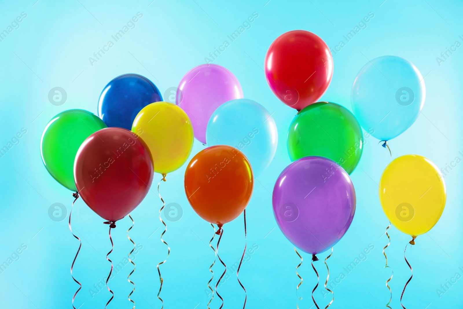 Photo of Bright balloons on color background. Celebration time