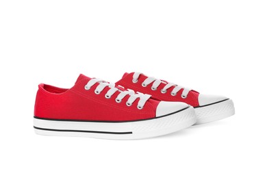 Photo of Pair of red classic old school sneakers on white background