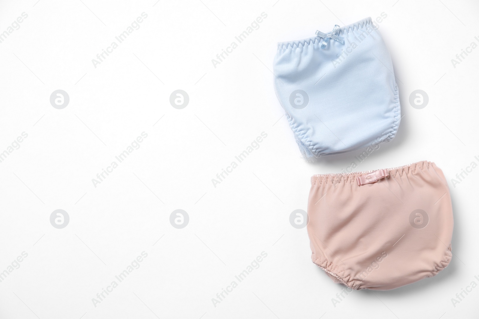 Photo of Stylish folded women's underwear on white background, flat lay. Space for text