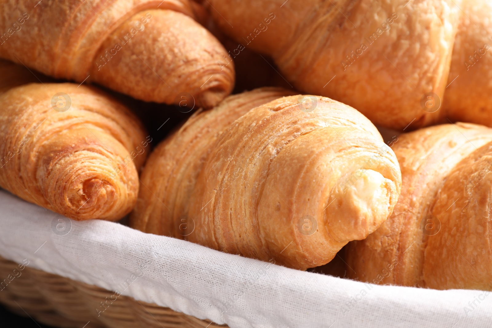 Photo of Closeup view of tasty fresh crispy croissants