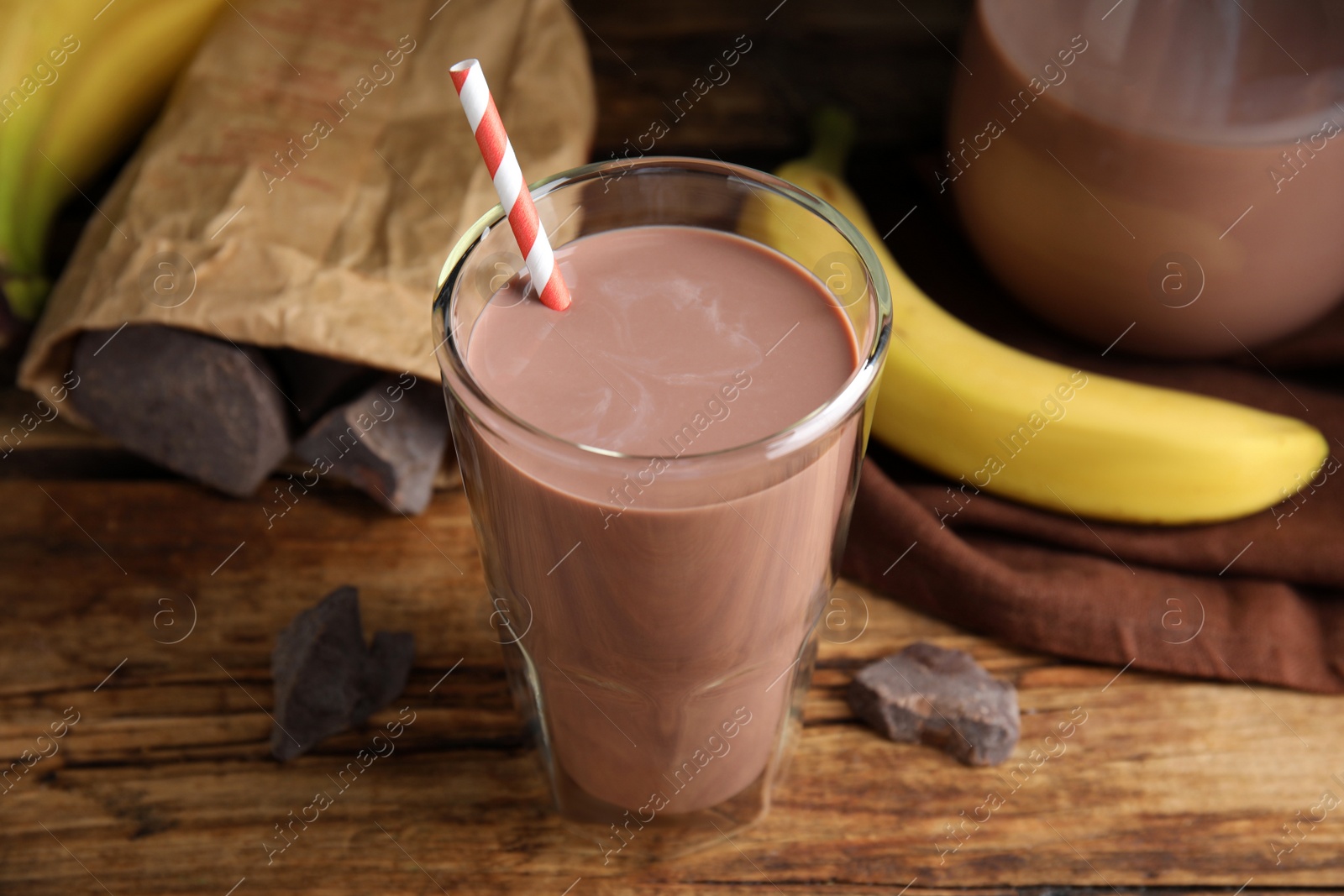 Photo of Fresh yummy chocolate milk on wooden table