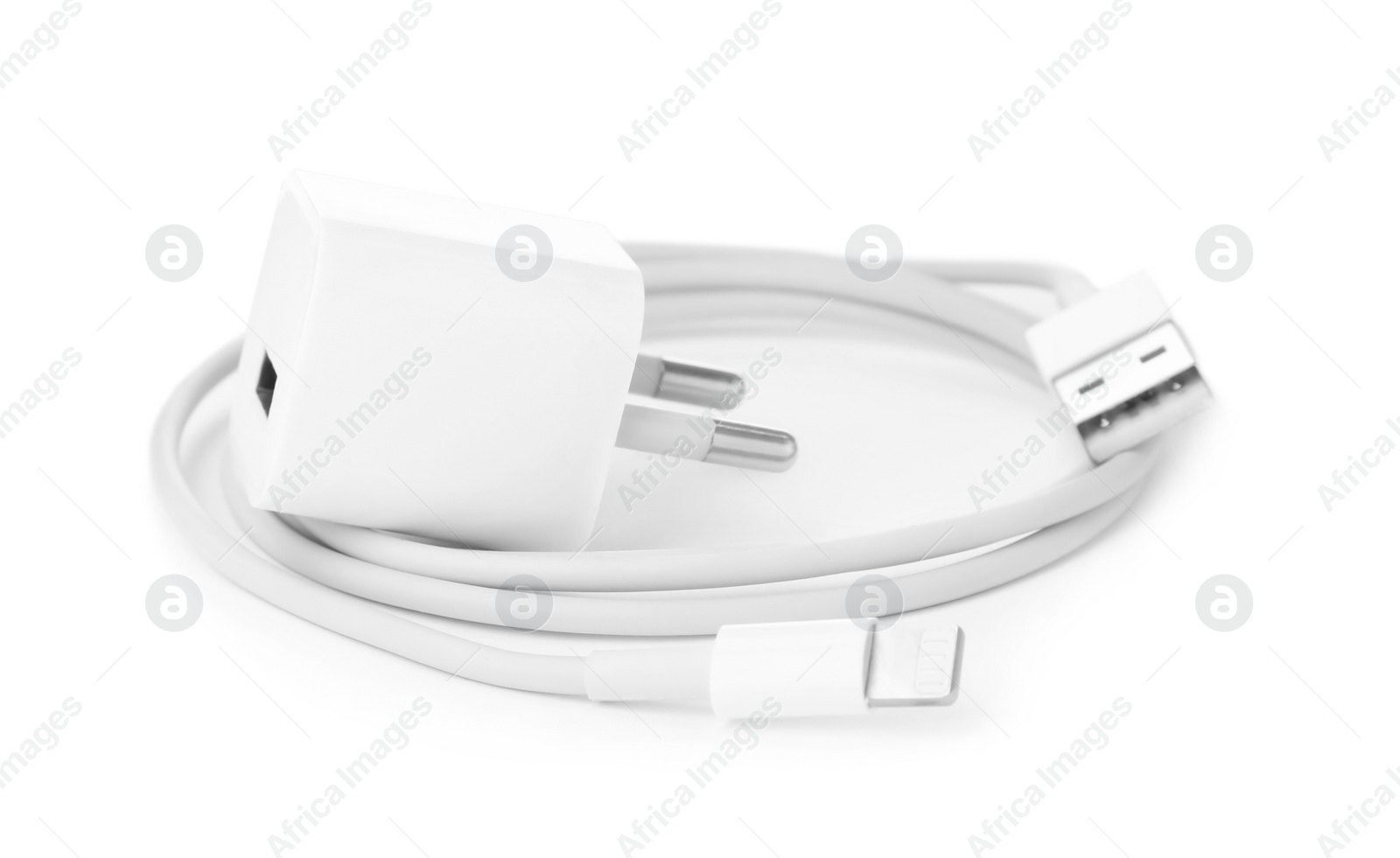 Photo of USB charge cable and power adapter on white background. Modern technology