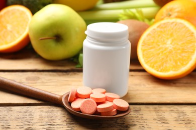 Photo of Dietary supplements. Bottle, pills in spoon and food products on wooden table