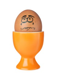 Photo of Egg with drawn unhappy face in cup isolated on white