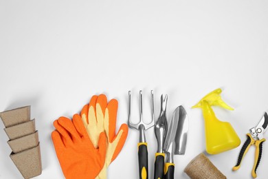 Flat lay composition with gardening tools on white background, space for text