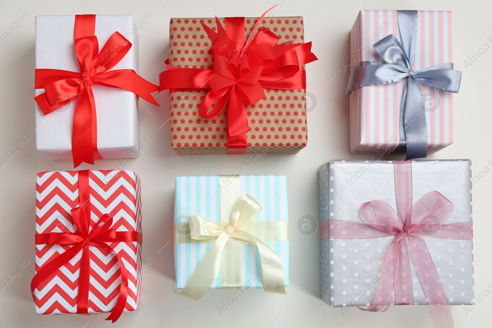 Photo of Beautifully decorated gift boxes on white background, top view