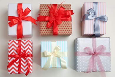 Photo of Beautifully decorated gift boxes on white background, top view