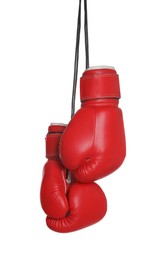 Photo of Pair of boxing gloves hanging on white background