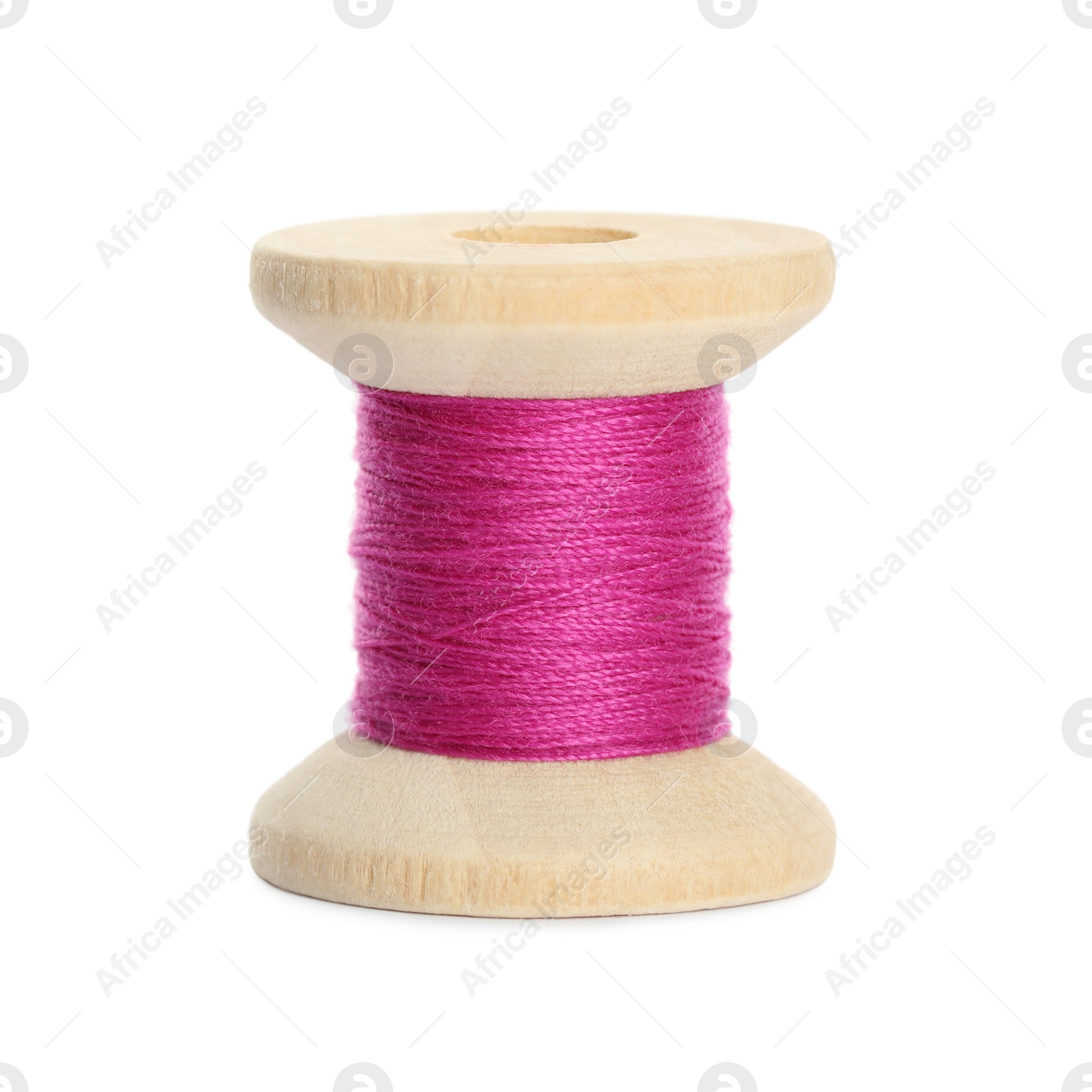 Photo of Wooden spool of bright pink sewing thread isolated on white