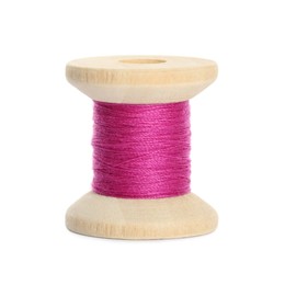 Photo of Wooden spool of bright pink sewing thread isolated on white