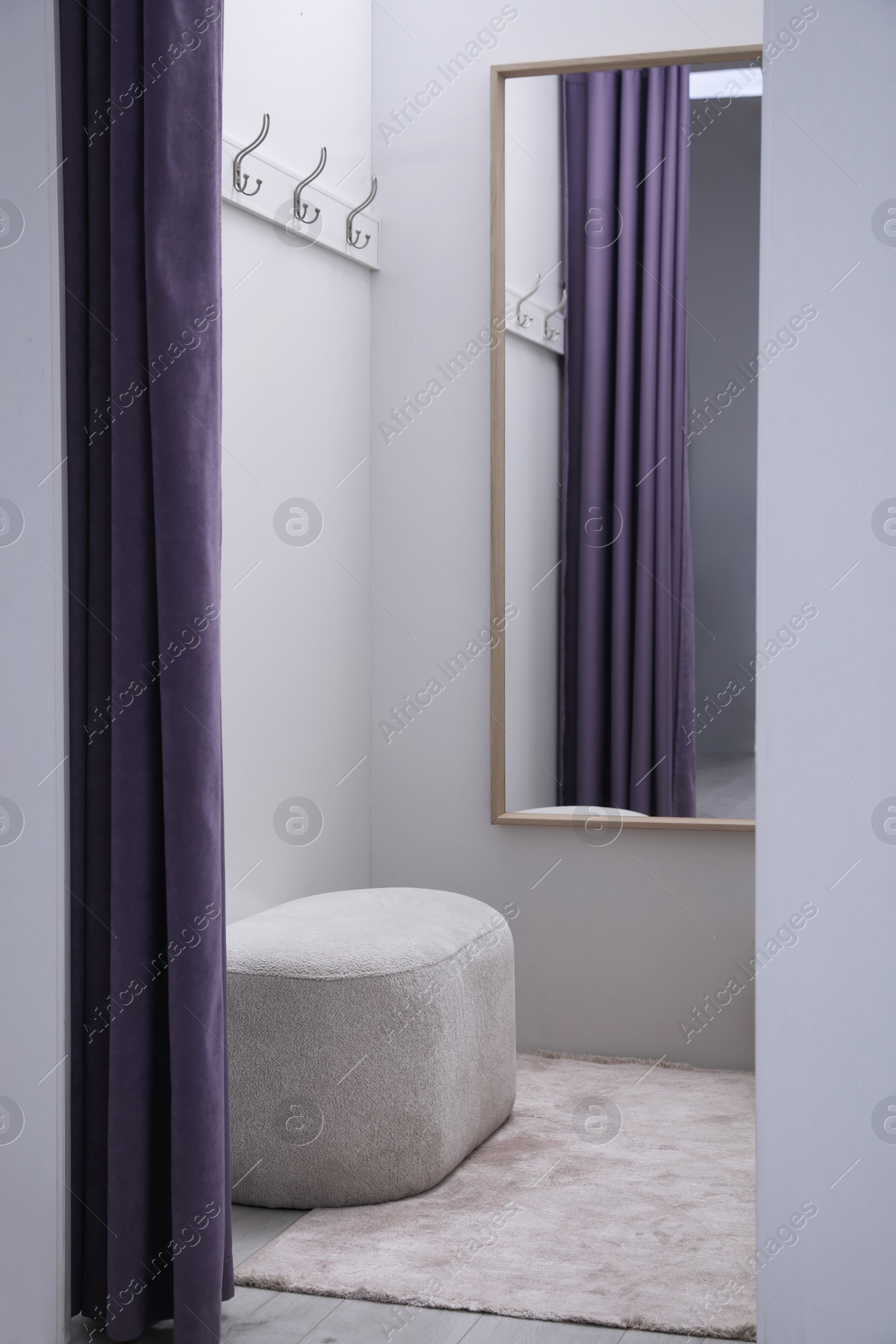 Photo of Empty dressing room in fashion store. Stylish interior