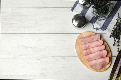 Photo of Tasty ham served on white wooden table, flat lay . Space for text