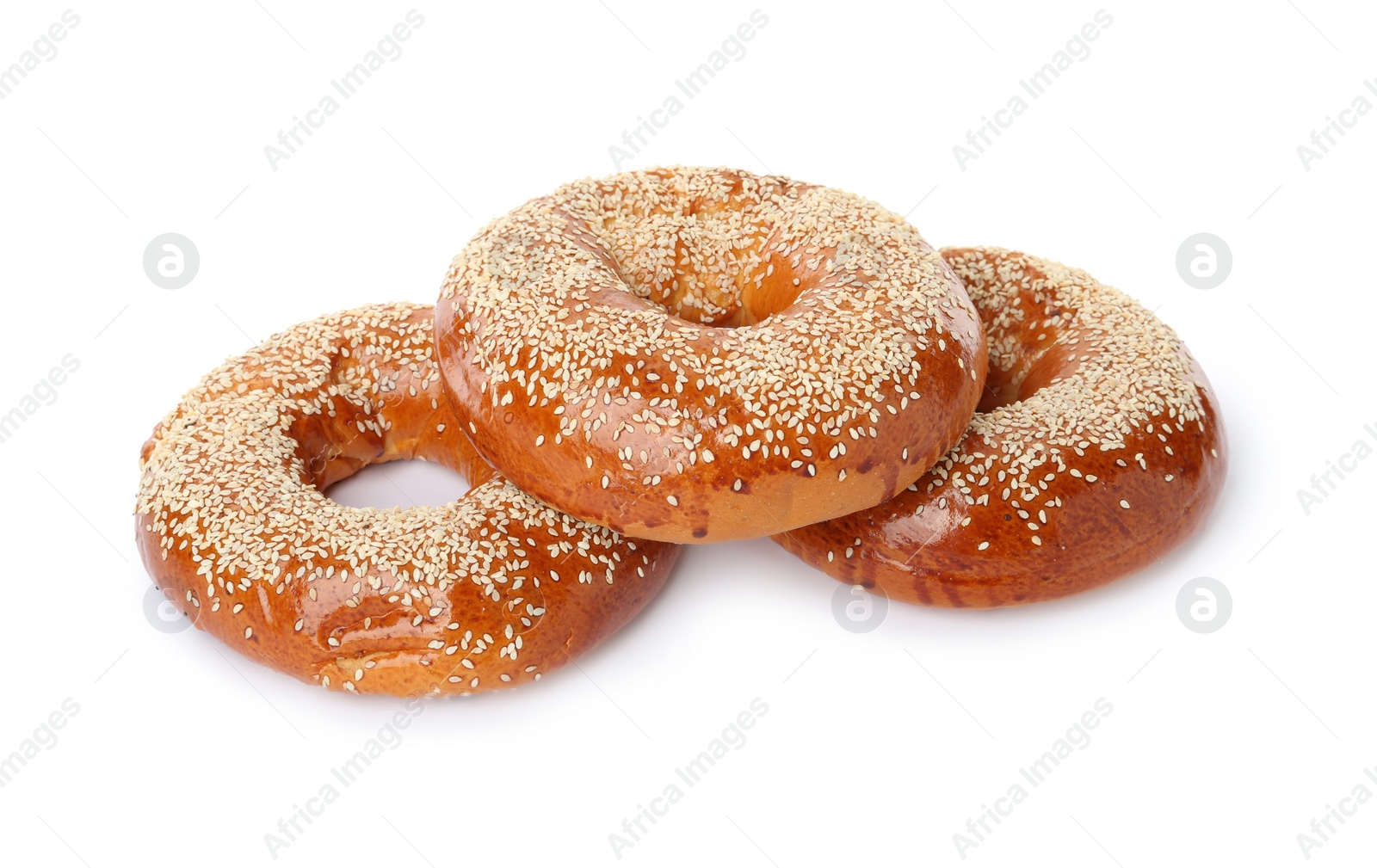 Photo of Delicious fresh bagels with sesame seeds on white background