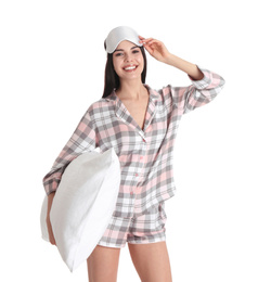 Young woman with pillow and sleep mask on white background