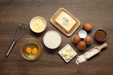 Photo of Flat lay composition with fresh butter among other products on wooden table