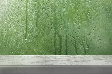 Image of White table near window on rainy day