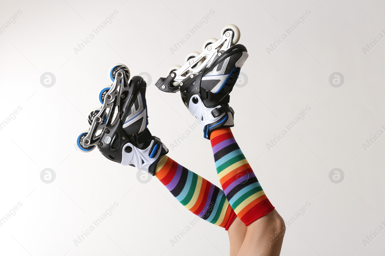 Photo of Woman with roller skates on white background, closeup