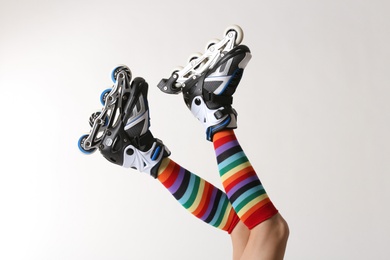 Photo of Woman with roller skates on white background, closeup