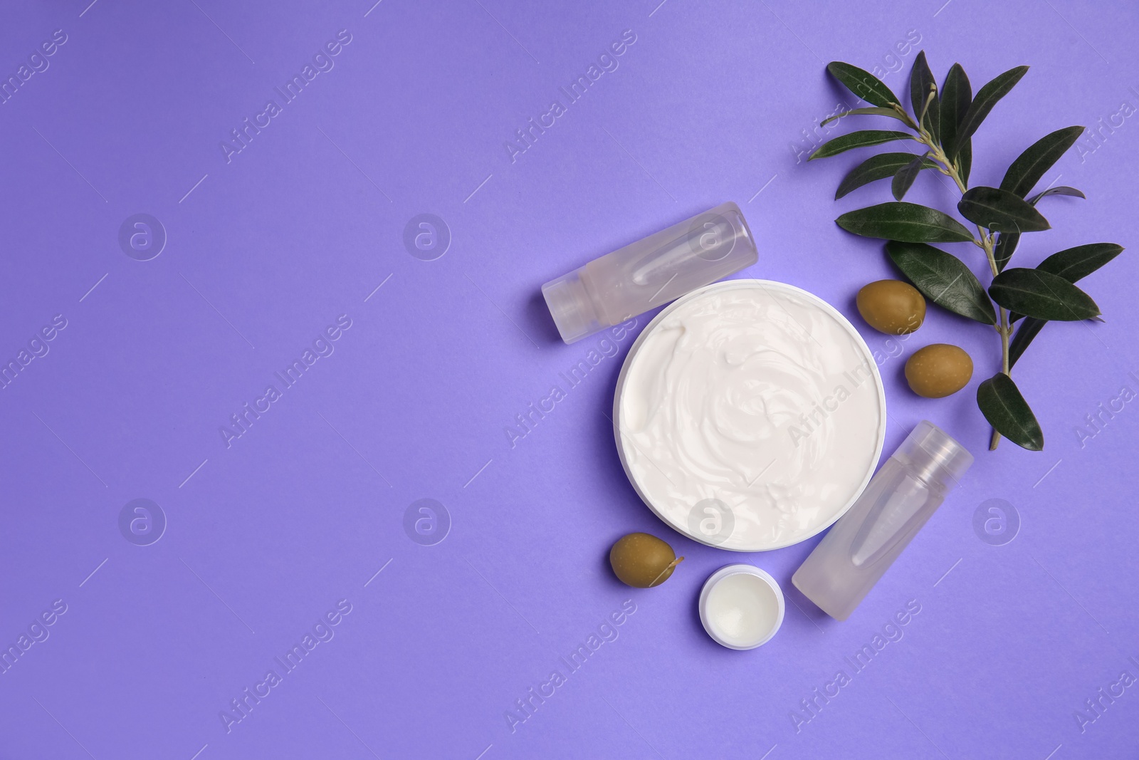 Photo of Different cosmetic products and olives on violet background, flat lay. Space for text