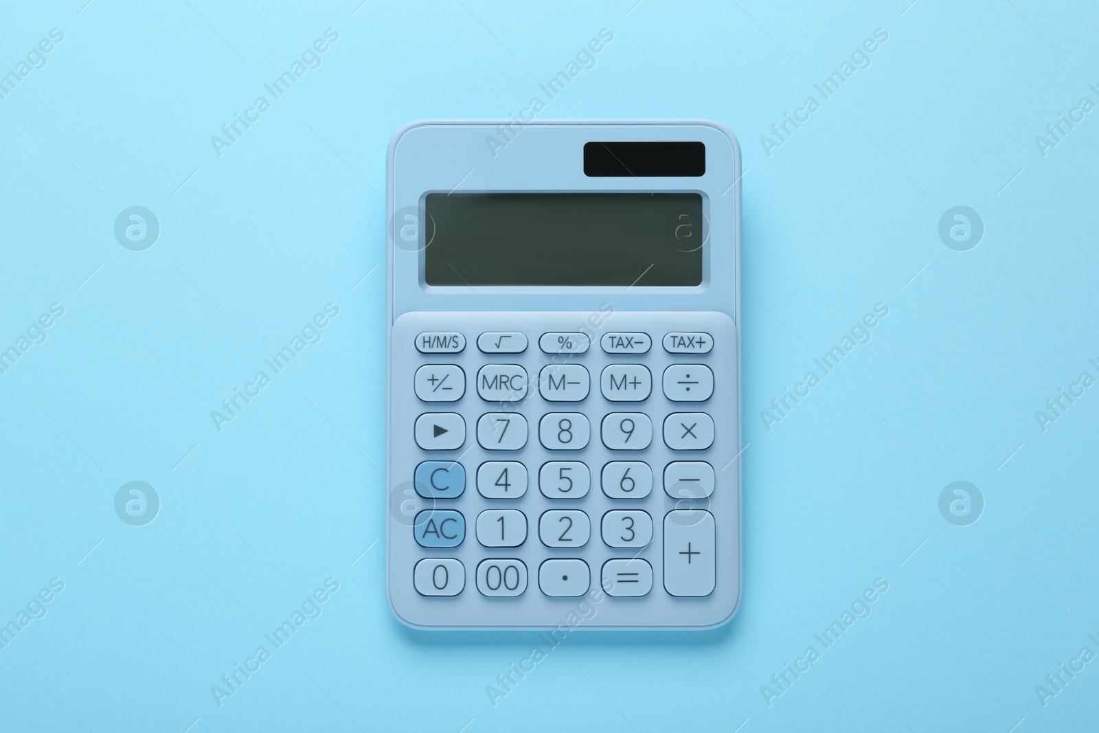 Photo of Modern calculator on light blue background, top view