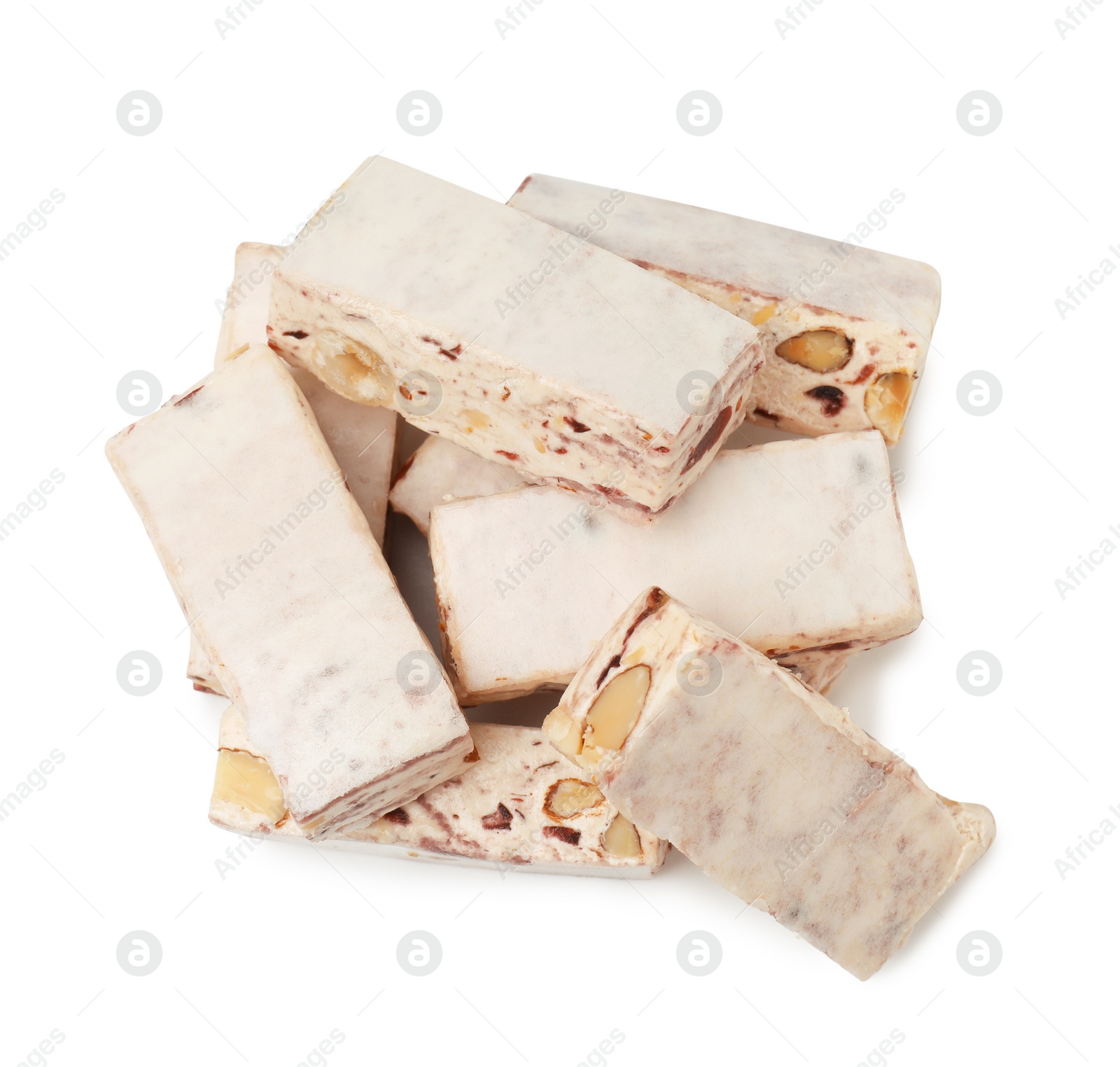 Photo of Many pieces of delicious nougat on white background, top view