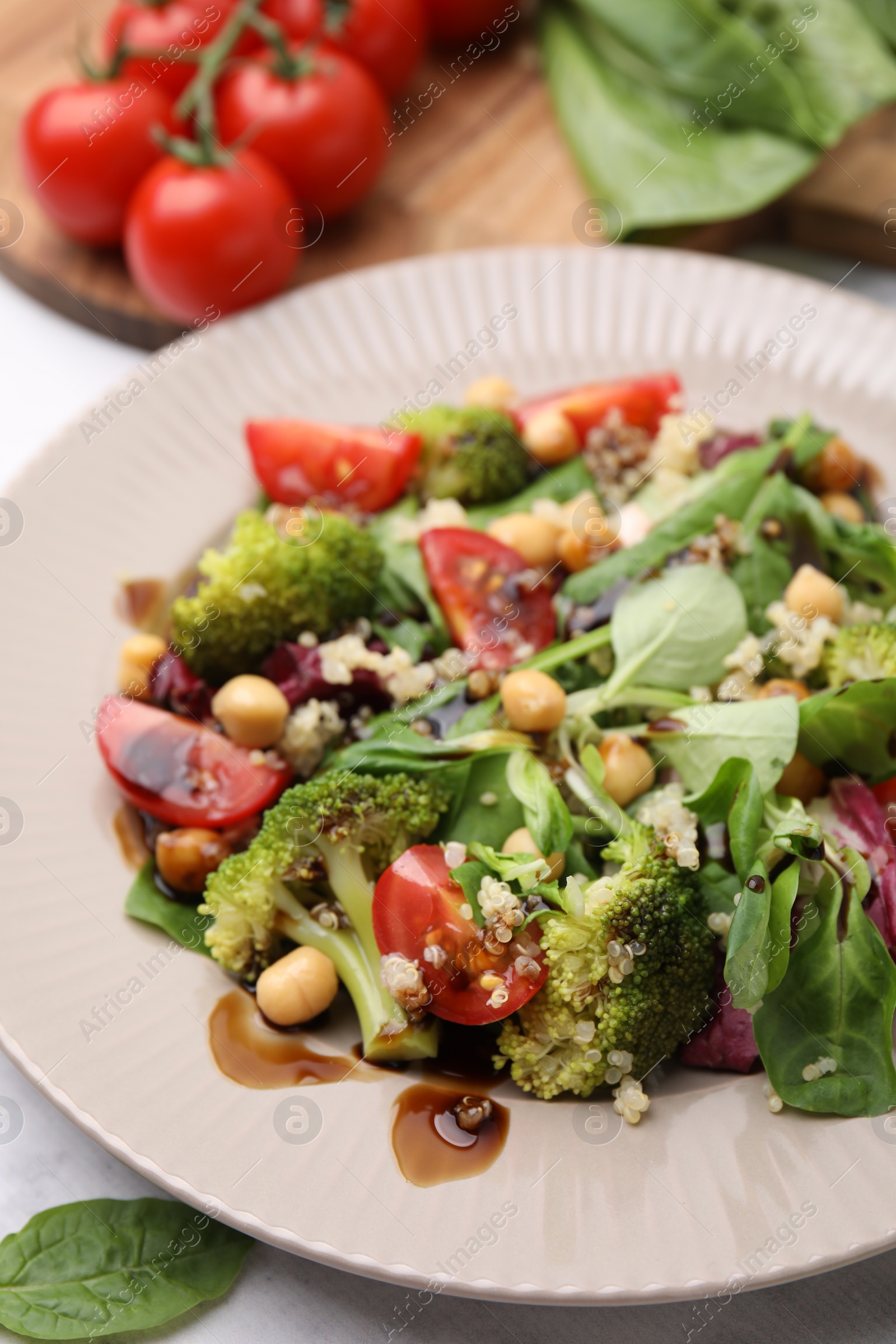 Photo of Tasty salad with balsamic vinegar on table, closeup