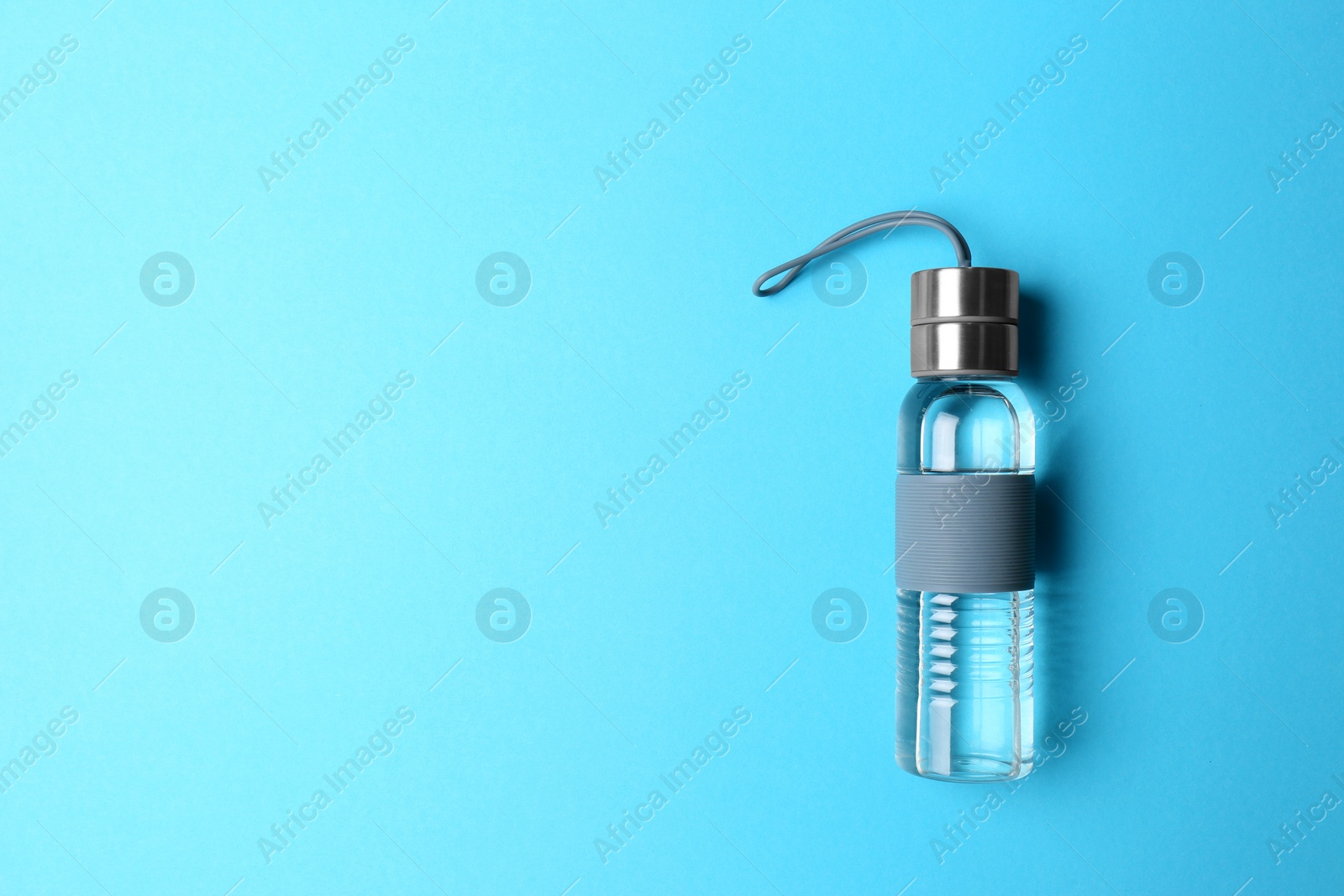 Photo of Sport bottle with space for text on color background, top view