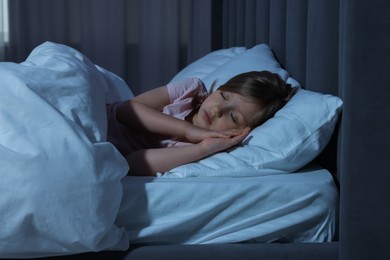 Photo of Little girl snoring while sleeping in bed at home